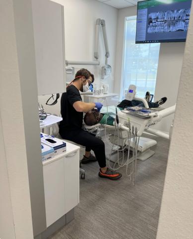 Dental hygienist with a patient during a dental cleaning.