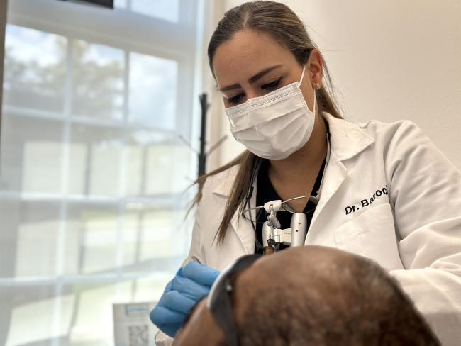 Doctor Barocio with a patient during a dental exam.