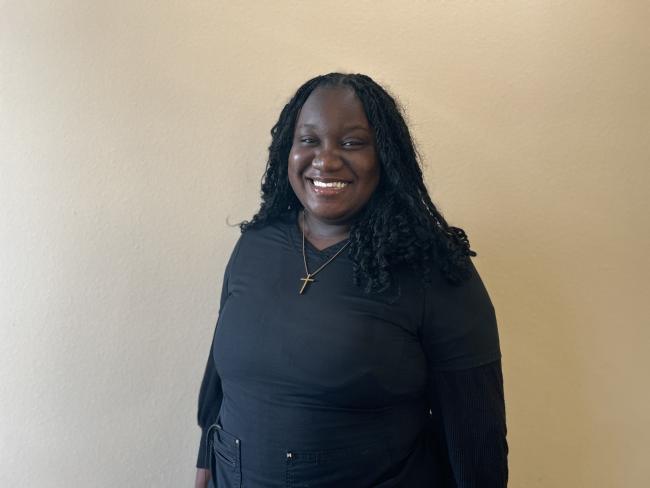 Team member looking at the camera and smiling