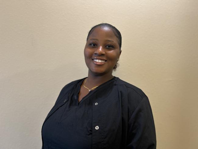 Team member looking at the camera and smiling